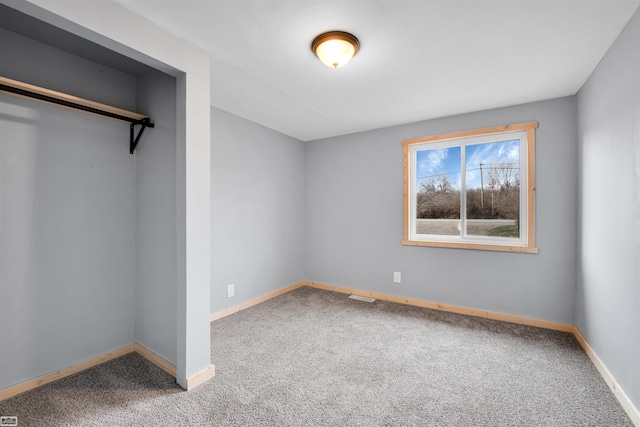 unfurnished bedroom featuring a closet and carpet floors