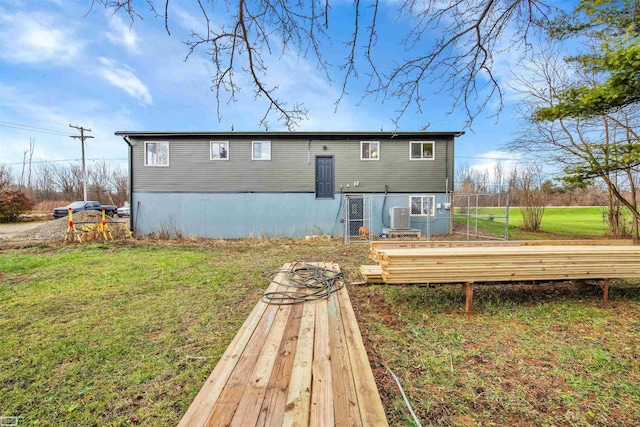 rear view of house with a yard