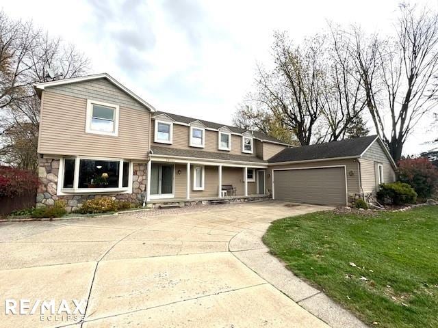 view of front of house featuring a front yard and a garage