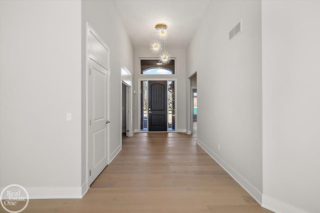 interior space with a chandelier and light hardwood / wood-style flooring