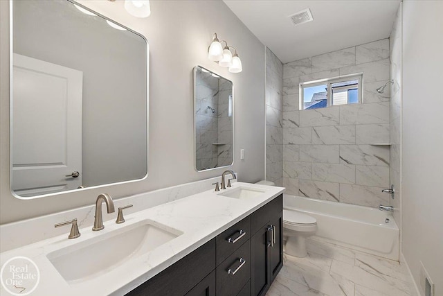 full bathroom featuring vanity, tiled shower / bath combo, and toilet