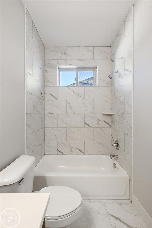 full bathroom with tiled shower / bath combo, toilet, and vanity