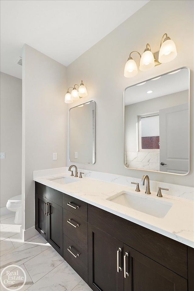 bathroom with vanity and toilet