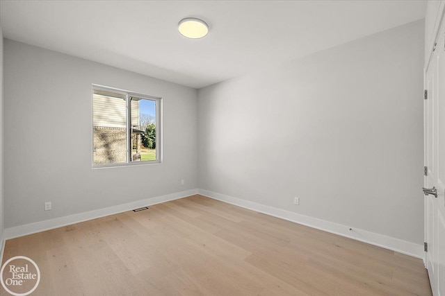 empty room with light hardwood / wood-style flooring