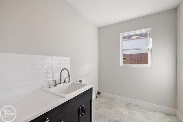 washroom featuring cabinets, hookup for a washing machine, and sink