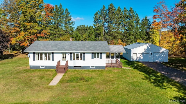 view of front of house with a front lawn, an outdoor structure, and a garage