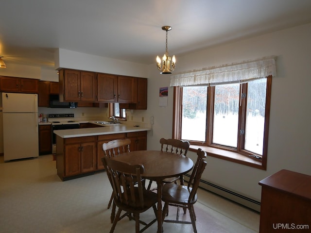 dining room featuring sink, a notable chandelier, and a baseboard heating unit