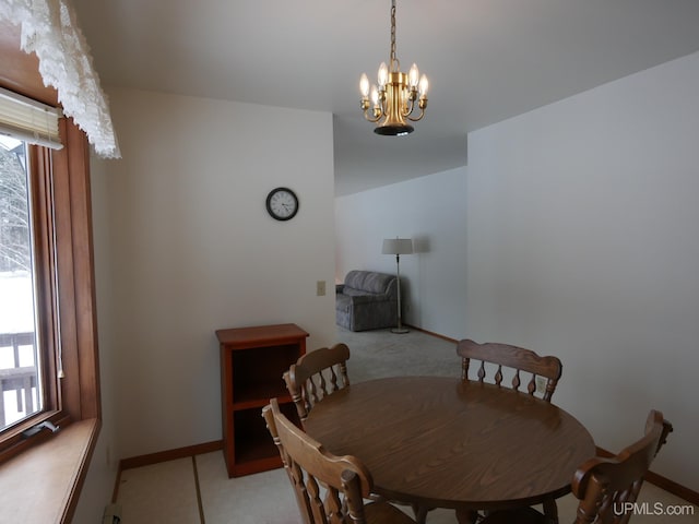 carpeted dining area with plenty of natural light and an inviting chandelier