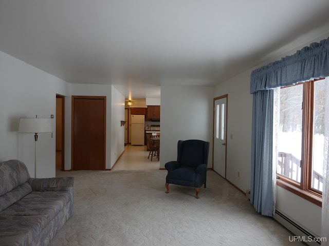 carpeted living room featuring a wealth of natural light and a baseboard heating unit