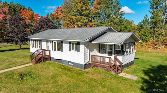 view of front of property featuring a sunroom and a front lawn