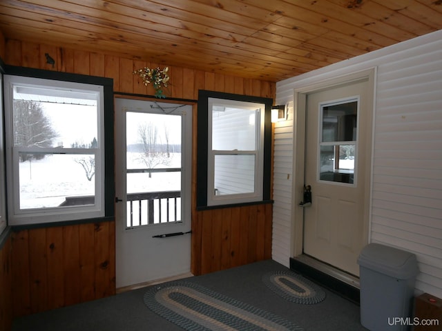 entryway with wooden ceiling and wooden walls