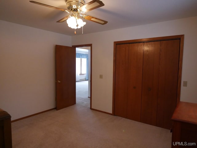 unfurnished bedroom with light colored carpet, a closet, and ceiling fan