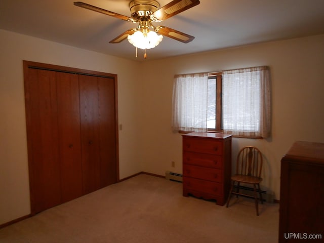 unfurnished bedroom featuring ceiling fan, a baseboard heating unit, light colored carpet, and a closet