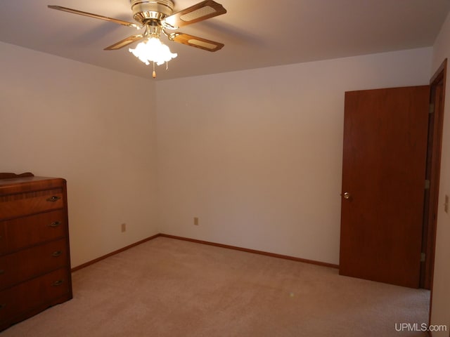 unfurnished bedroom featuring ceiling fan and light carpet