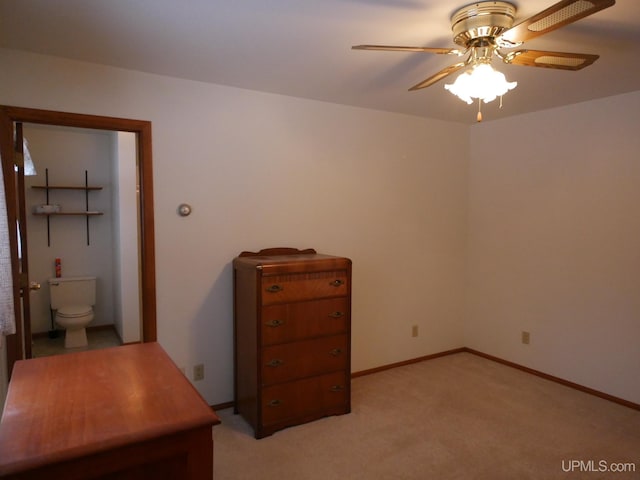 carpeted bedroom featuring ensuite bathroom and ceiling fan