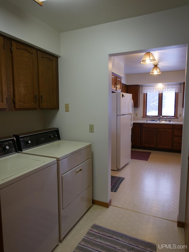 laundry area featuring washer and dryer and sink