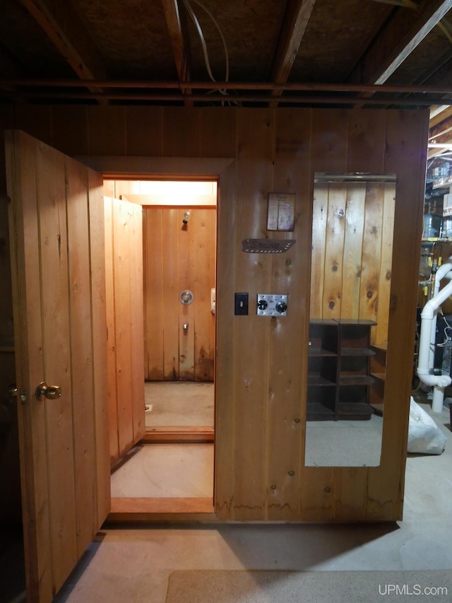 hallway with wood walls