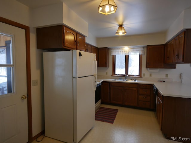 kitchen with black dishwasher, white refrigerator, and sink