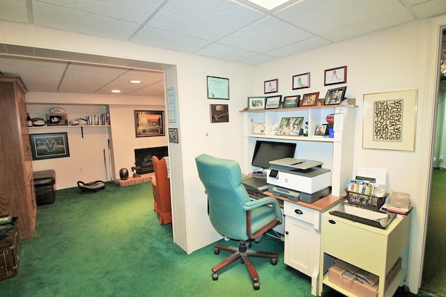 home office with dark colored carpet and a drop ceiling