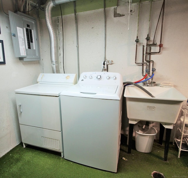 laundry room with sink, electric panel, and washing machine and clothes dryer