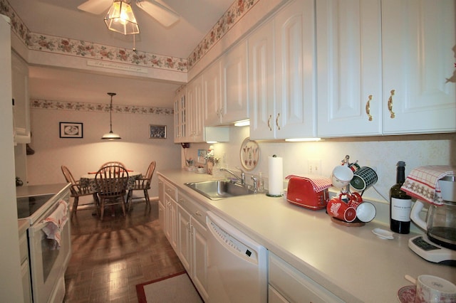 kitchen with white appliances, dark parquet floors, sink, white cabinets, and hanging light fixtures