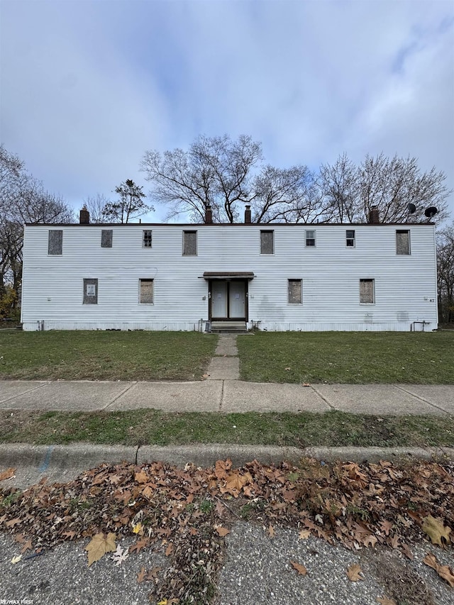 rear view of property with a yard