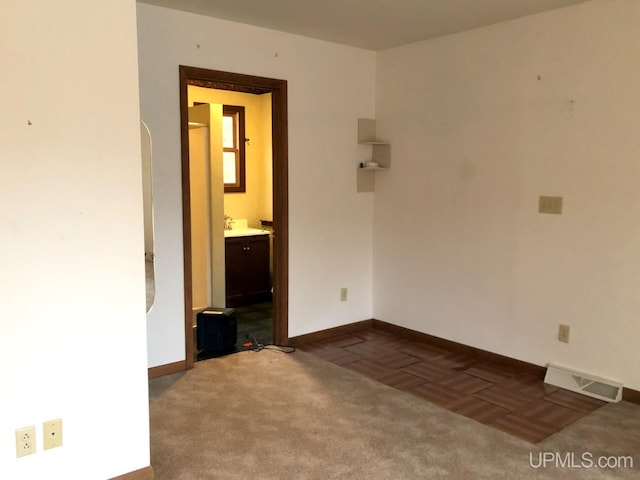 carpeted empty room with sink