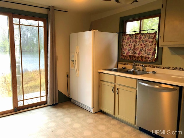 kitchen with stainless steel dishwasher, white refrigerator with ice dispenser, and sink