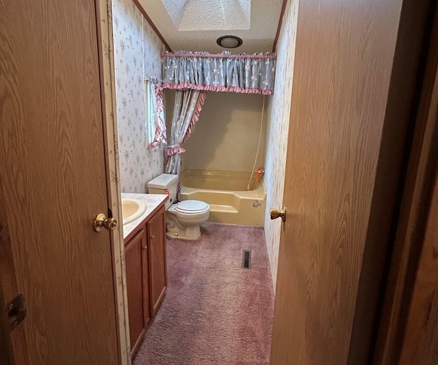 full bathroom featuring a skylight, a textured ceiling, toilet, vanity, and shower / bathtub combination