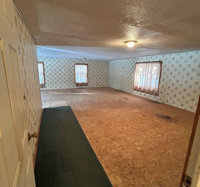 basement with plenty of natural light and a textured ceiling