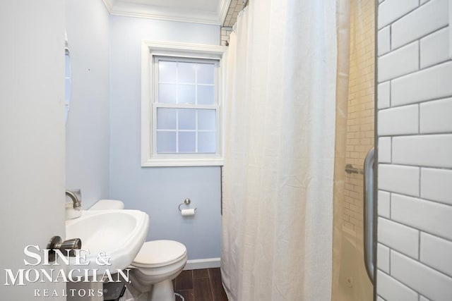 bathroom with hardwood / wood-style floors, toilet, ornamental molding, and sink