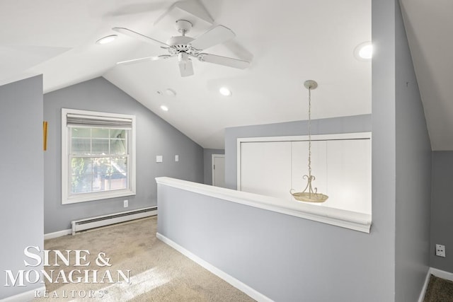 hallway featuring light carpet, a baseboard radiator, and lofted ceiling