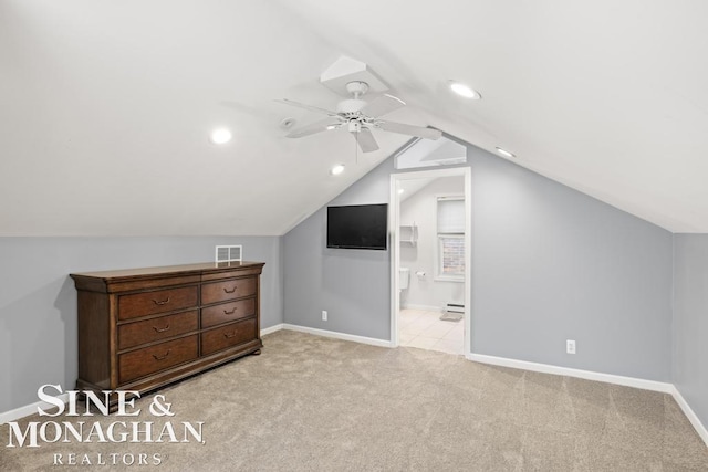 additional living space with ceiling fan, lofted ceiling, light carpet, and baseboard heating