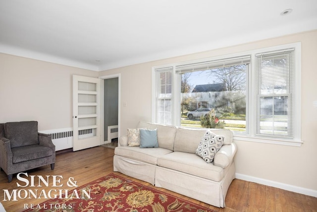 living room with hardwood / wood-style flooring and radiator