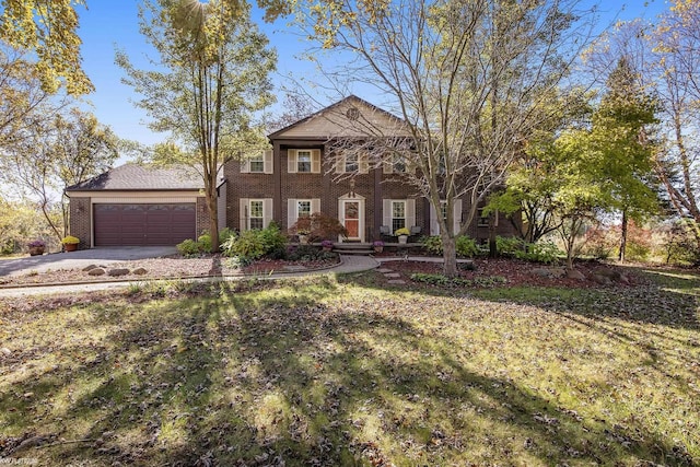 view of front of house featuring a garage and a front lawn