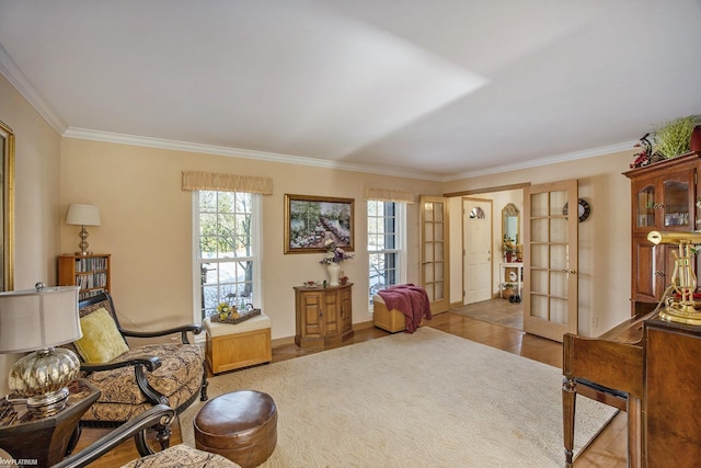 living area with french doors, light hardwood / wood-style floors, and ornamental molding