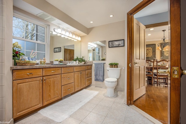 bathroom featuring a chandelier, wood-type flooring, vanity, and toilet