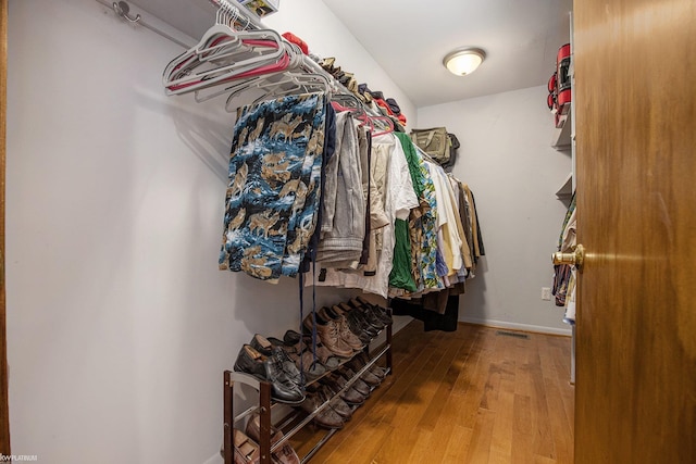 walk in closet with wood-type flooring