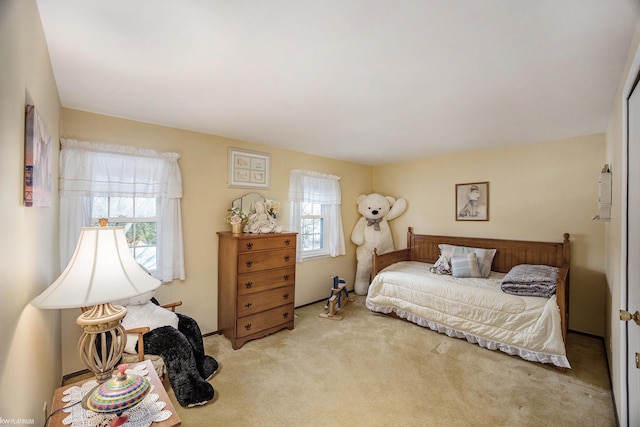 carpeted bedroom with multiple windows