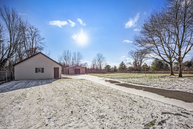 view of yard featuring an outbuilding and a garage