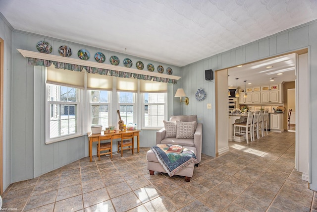 sitting room featuring tile patterned flooring and crown molding