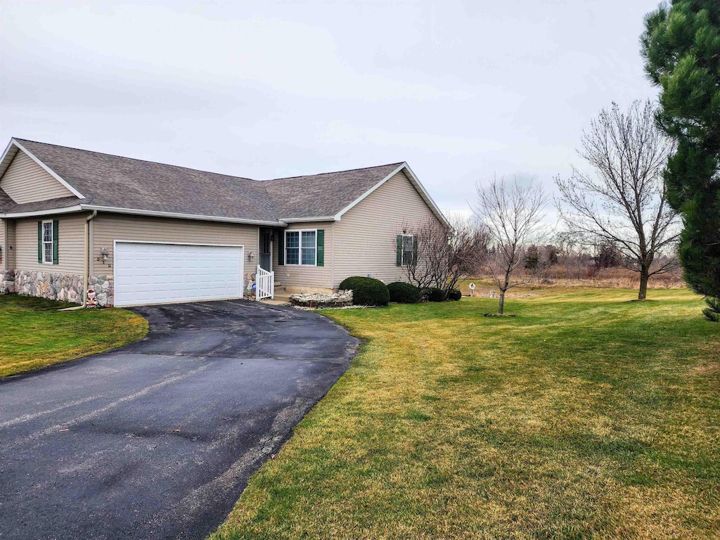 single story home with a front lawn and a garage