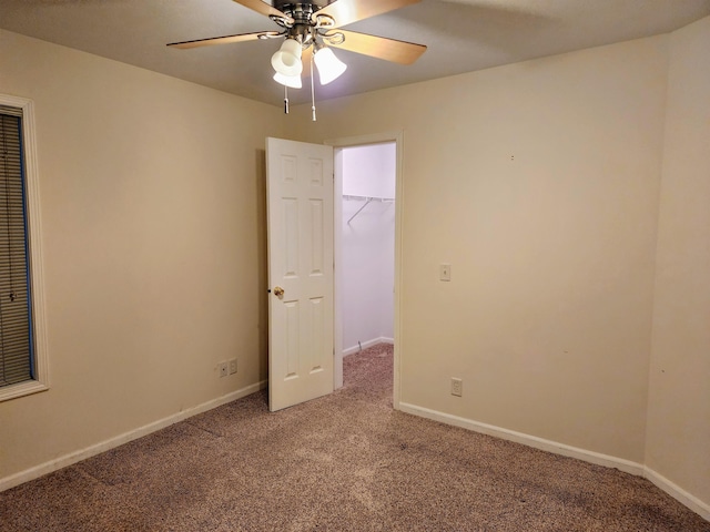 carpeted empty room featuring ceiling fan