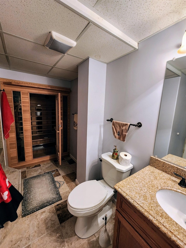 bathroom featuring a paneled ceiling, vanity, and toilet