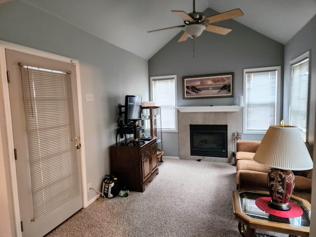 living room featuring ceiling fan, a fireplace, carpet floors, and lofted ceiling