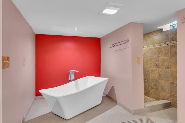 bathroom featuring tile patterned floors and separate shower and tub