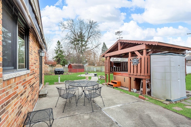 view of patio featuring a shed