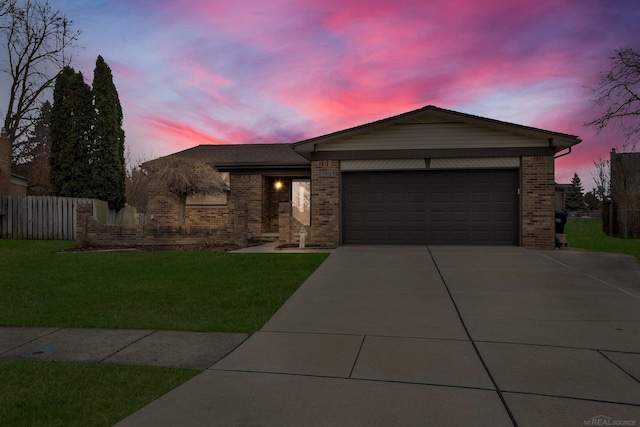 view of front of house featuring a garage and a yard