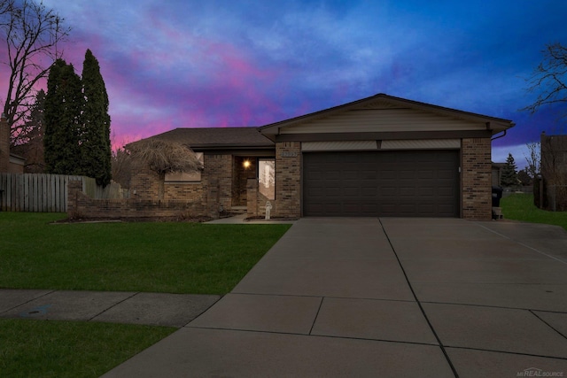 view of front facade with a garage and a lawn