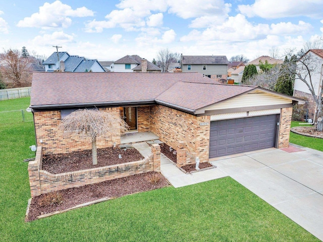 ranch-style home featuring a garage and a front lawn